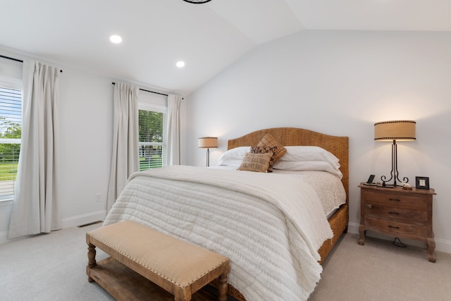 bedroom featuring lofted ceiling and light carpet