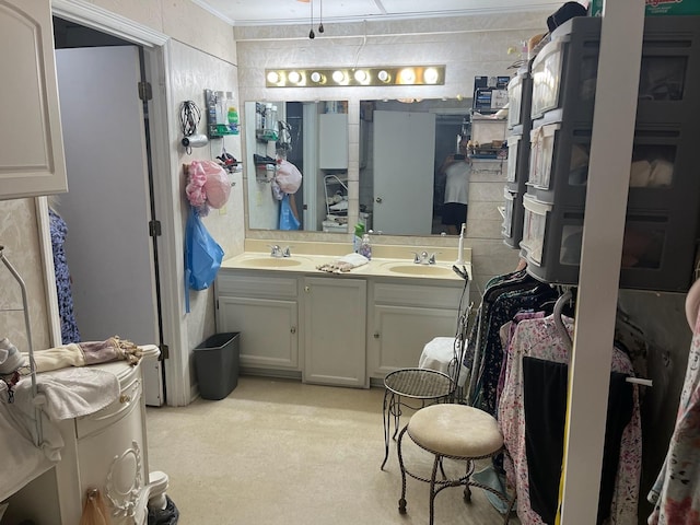 full bathroom with double vanity, a sink, and crown molding