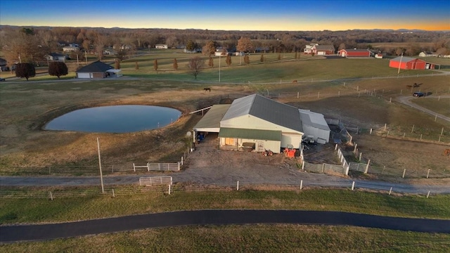 aerial view at dusk featuring a rural view