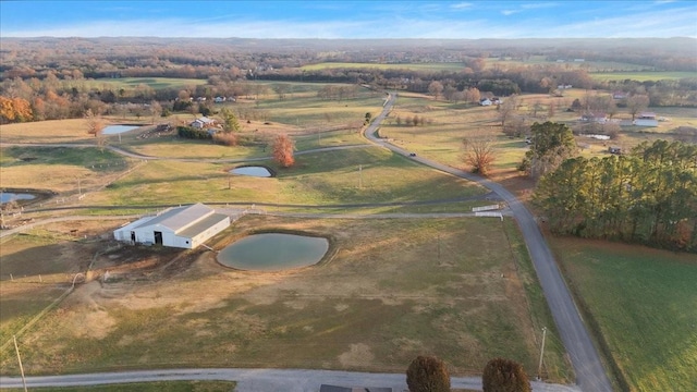 bird's eye view with a water view and a rural view