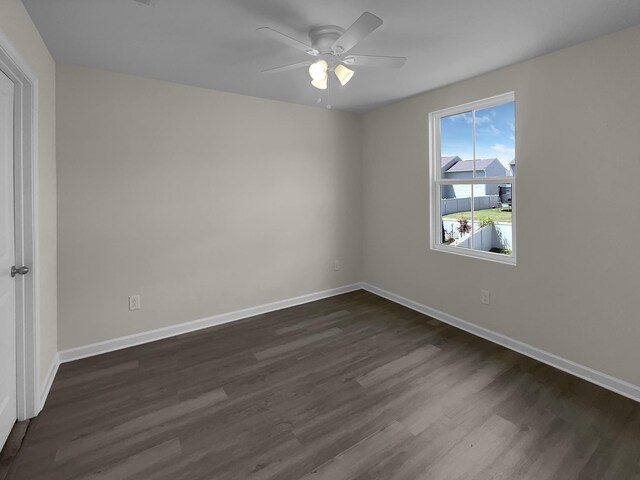 unfurnished room featuring ceiling fan and dark hardwood / wood-style flooring