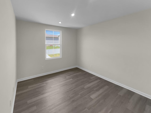 unfurnished room with wood-type flooring