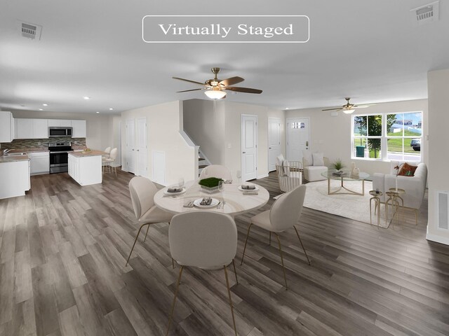 dining space featuring ceiling fan, sink, and hardwood / wood-style flooring