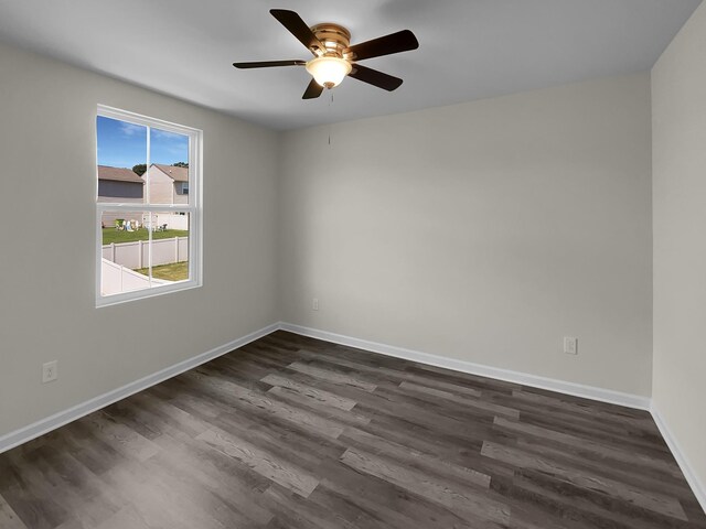 empty room with ceiling fan and dark hardwood / wood-style flooring