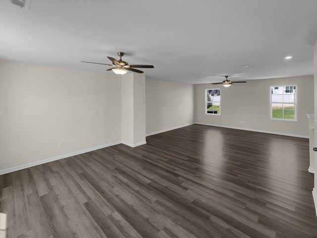 spare room featuring dark wood-type flooring and ceiling fan