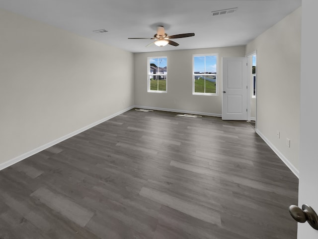 empty room featuring ceiling fan and dark wood-type flooring