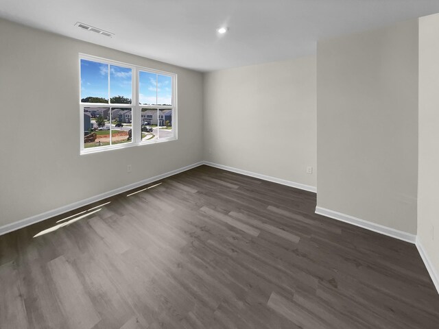 spare room with dark hardwood / wood-style flooring