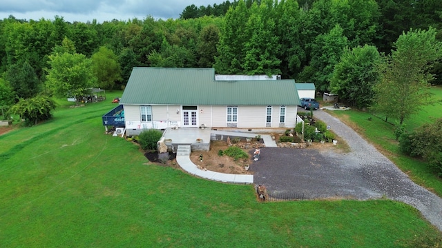 back of property featuring a yard