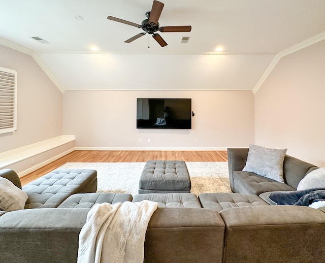 living room featuring ceiling fan, lofted ceiling, ornamental molding, and light wood-type flooring