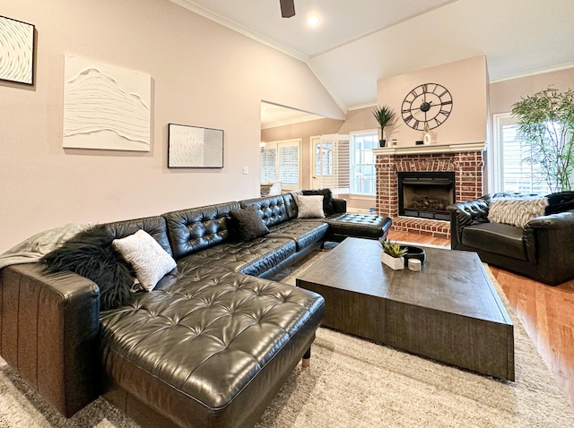 living room with hardwood / wood-style flooring, vaulted ceiling, plenty of natural light, and crown molding