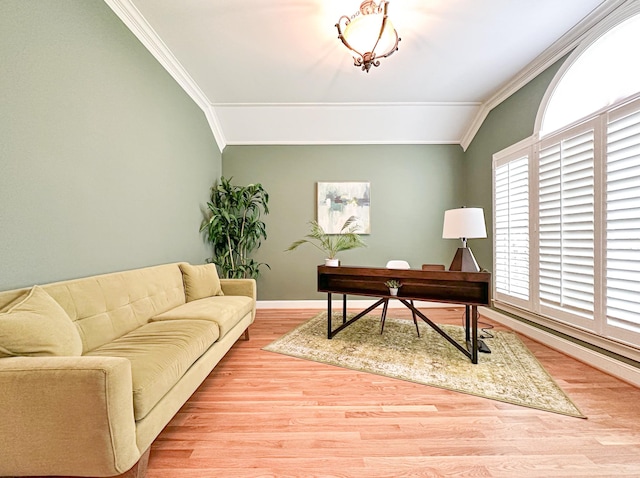 home office with crown molding, lofted ceiling, and light hardwood / wood-style flooring