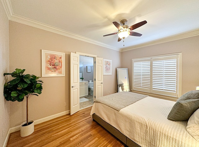 bedroom featuring ensuite bath, light hardwood / wood-style flooring, ornamental molding, and ceiling fan