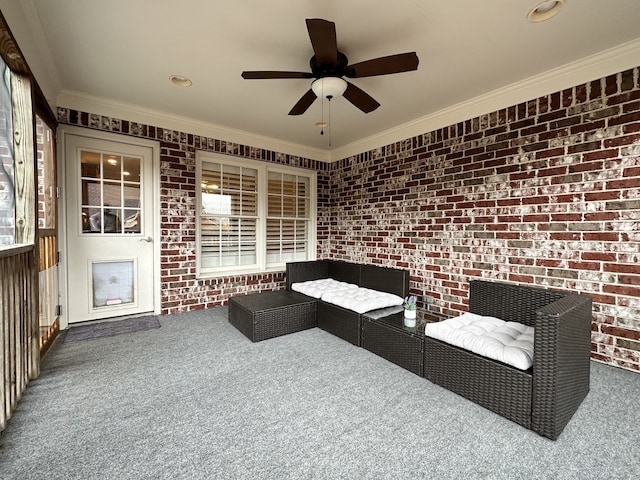 exterior space featuring brick wall, carpet flooring, crown molding, and ceiling fan