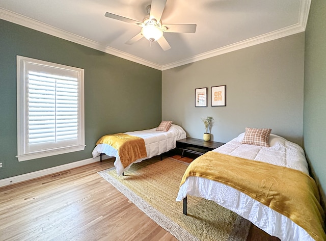 bedroom featuring ceiling fan, ornamental molding, and light hardwood / wood-style floors