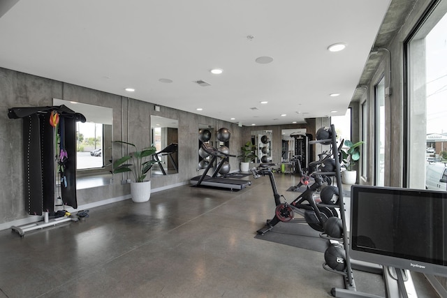 exercise room featuring concrete floors