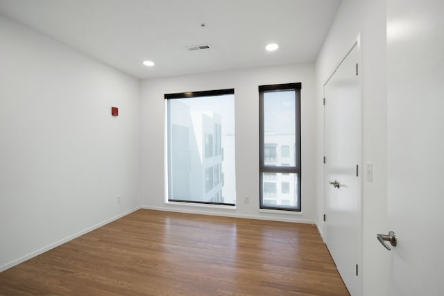 empty room with wood-type flooring