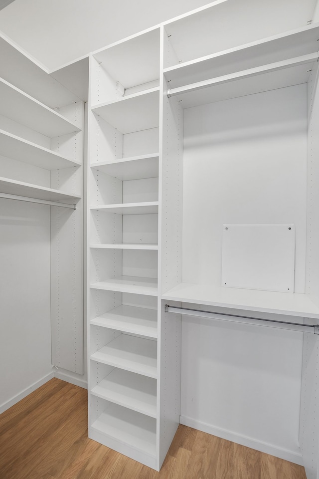 walk in closet featuring light hardwood / wood-style flooring