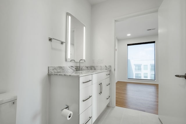 bathroom featuring tile patterned floors, vanity, and toilet