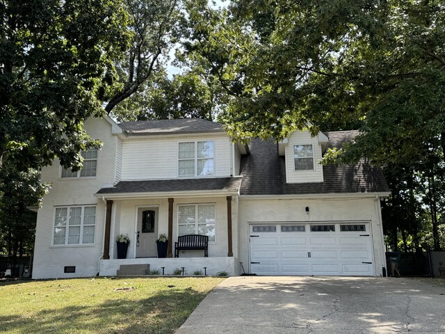 view of front of house featuring a front lawn and a garage