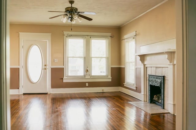 interior space with ornamental molding, hardwood / wood-style floors, ceiling fan, and a fireplace