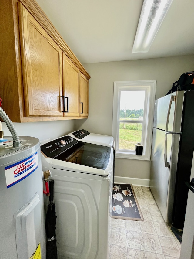 clothes washing area with electric water heater, cabinets, light tile patterned floors, and washer and clothes dryer