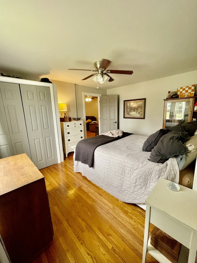 bedroom with a closet, ceiling fan, and light hardwood / wood-style floors