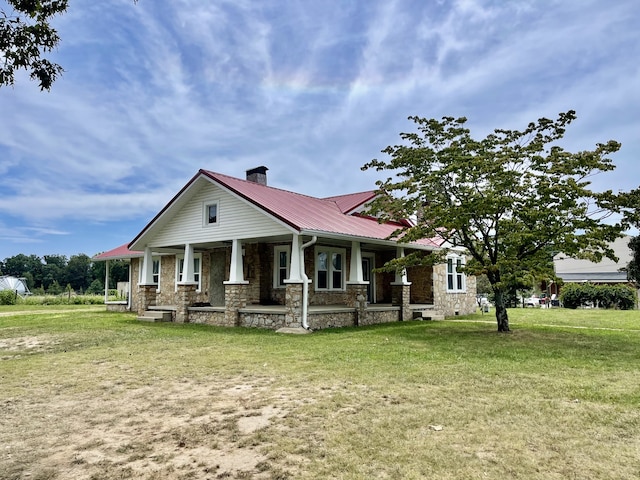 view of front of home featuring a front yard and covered porch