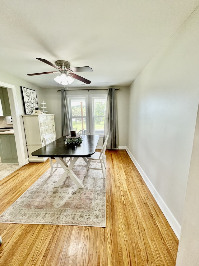 unfurnished dining area with ceiling fan and light hardwood / wood-style floors