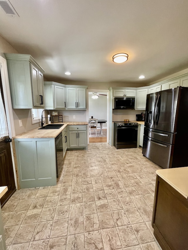 kitchen featuring appliances with stainless steel finishes, sink, light tile patterned floors, and gray cabinets