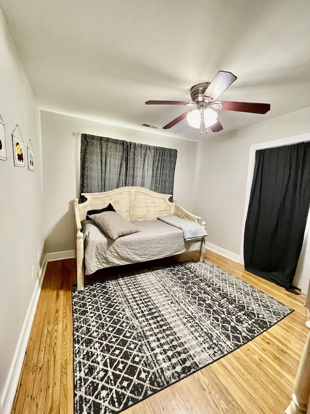 bedroom featuring ceiling fan and hardwood / wood-style flooring