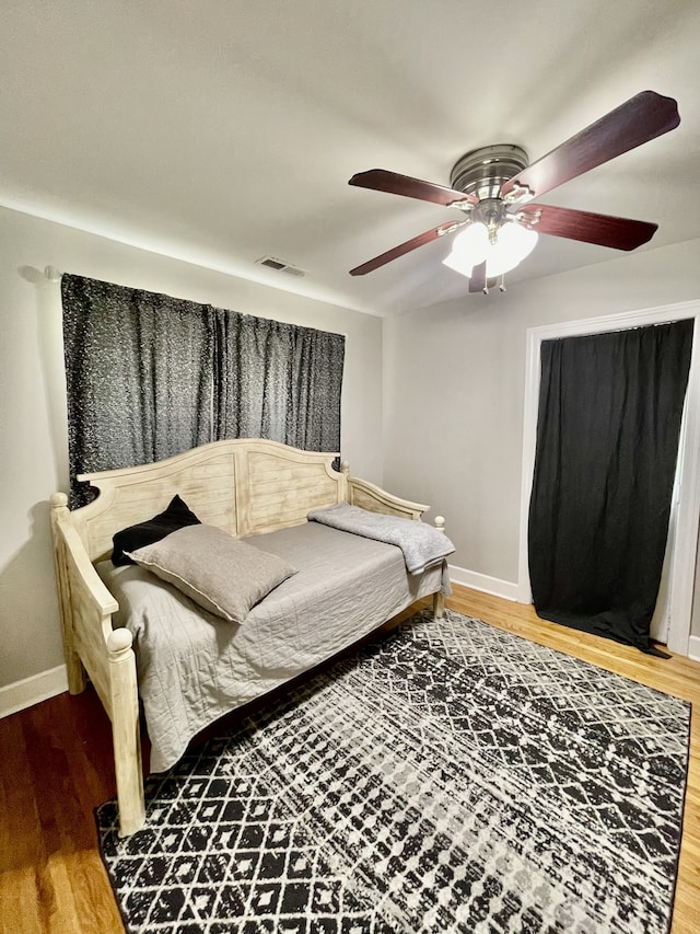 bedroom with ceiling fan and wood-type flooring