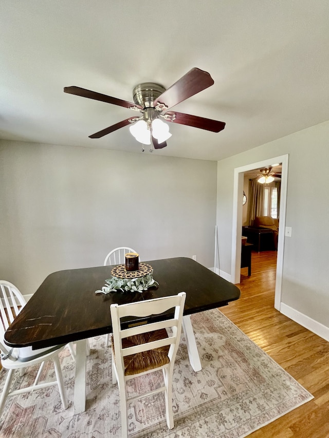 unfurnished dining area with ceiling fan and light wood-type flooring