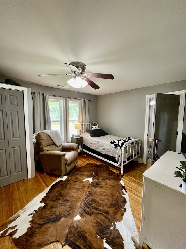 bedroom with ceiling fan and light wood-type flooring