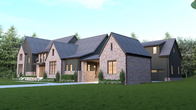 modern farmhouse with brick siding, roof with shingles, board and batten siding, and a front yard