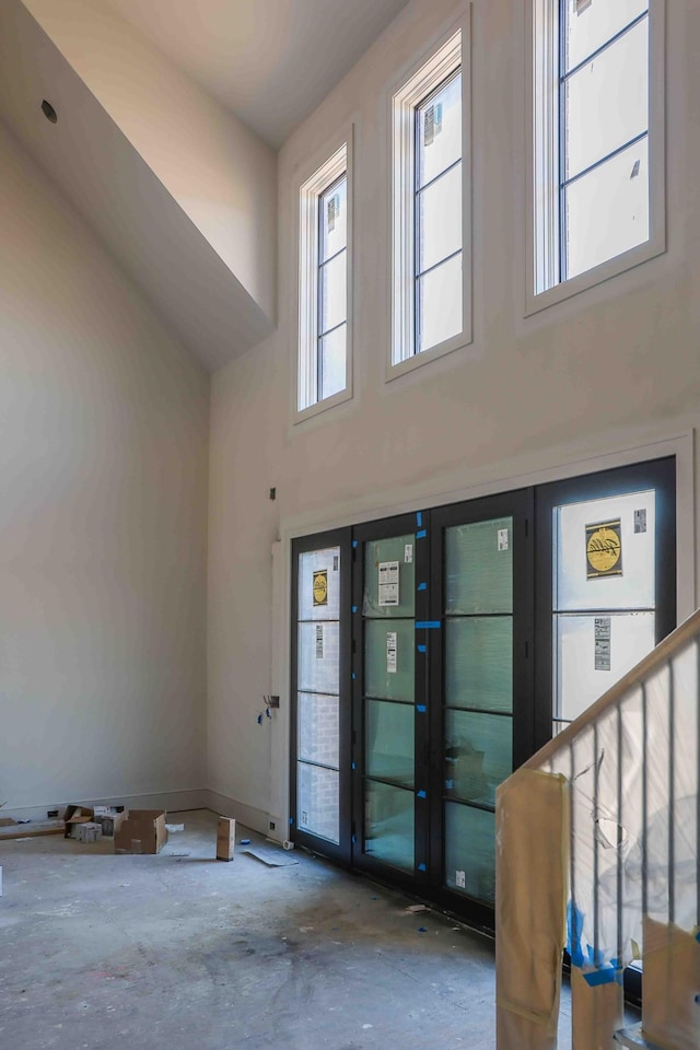 entrance foyer featuring stairs and a towering ceiling