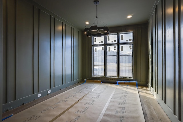 unfurnished room featuring a notable chandelier