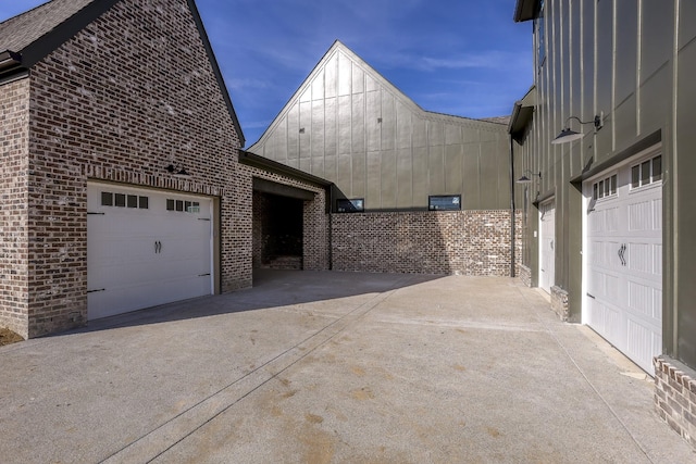 view of side of property with a garage and brick siding