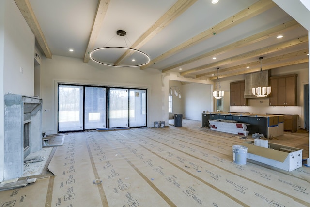 living area with a fireplace, beam ceiling, and recessed lighting