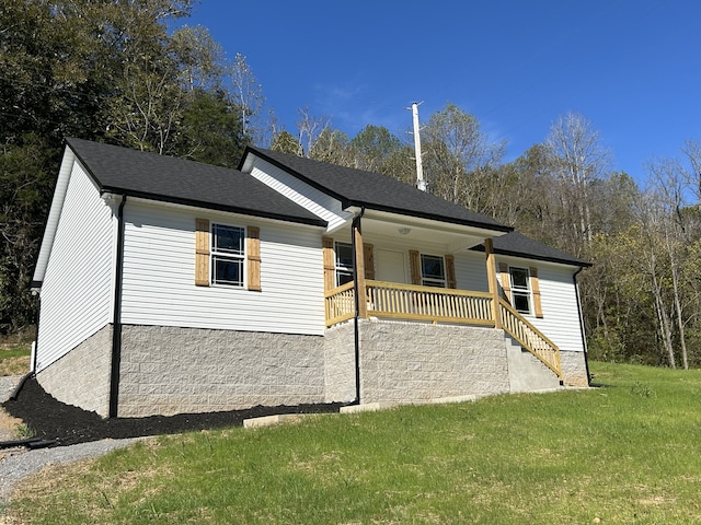 view of home's exterior with covered porch and a yard