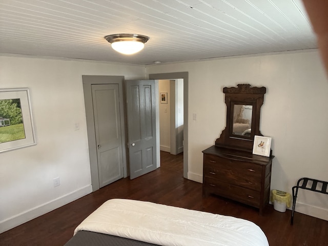 bedroom with dark wood-type flooring and crown molding