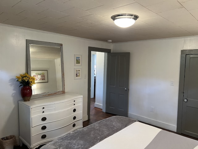 bedroom with dark hardwood / wood-style floors