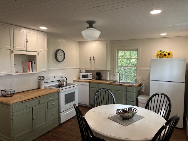 kitchen featuring white appliances, green cabinetry, white cabinetry, sink, and dark hardwood / wood-style floors