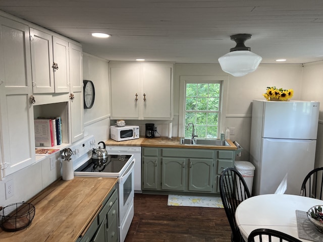 kitchen featuring white appliances, dark hardwood / wood-style floors, wooden counters, white cabinets, and sink