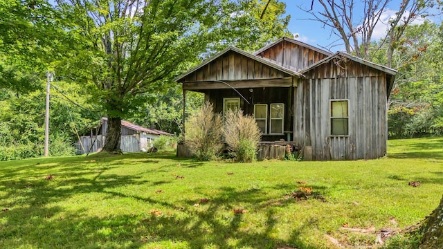 view of outbuilding featuring a lawn