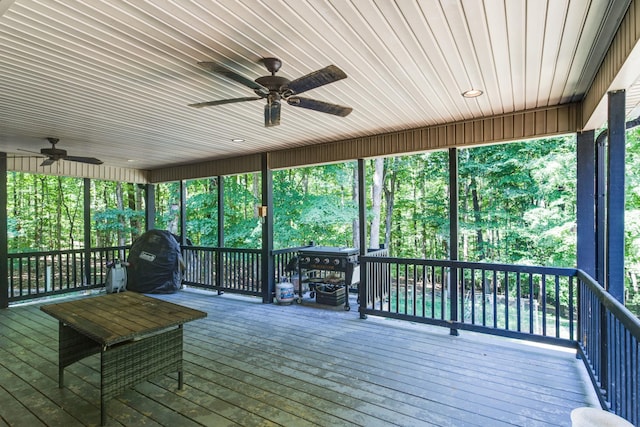 unfurnished sunroom featuring ceiling fan