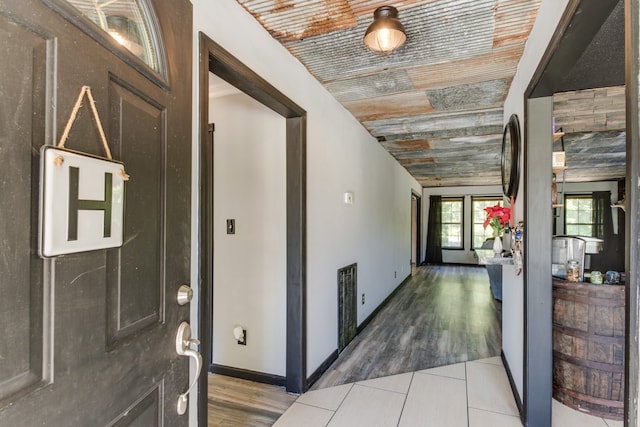 hall featuring wood ceiling and hardwood / wood-style flooring