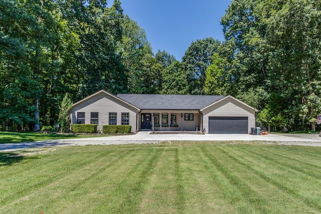 ranch-style house featuring a front lawn and a garage