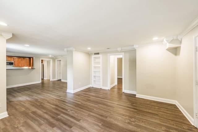 interior space with dark wood-style floors, ornamental molding, visible vents, and baseboards