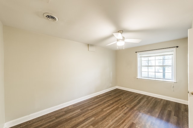 spare room featuring ceiling fan and dark hardwood / wood-style floors