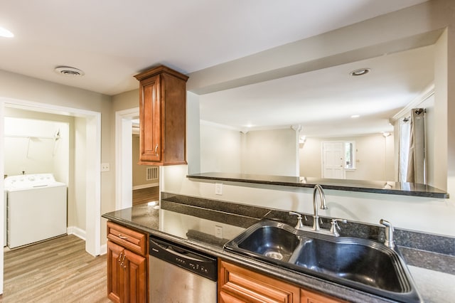 kitchen with light wood-type flooring, dishwasher, washer / dryer, sink, and kitchen peninsula